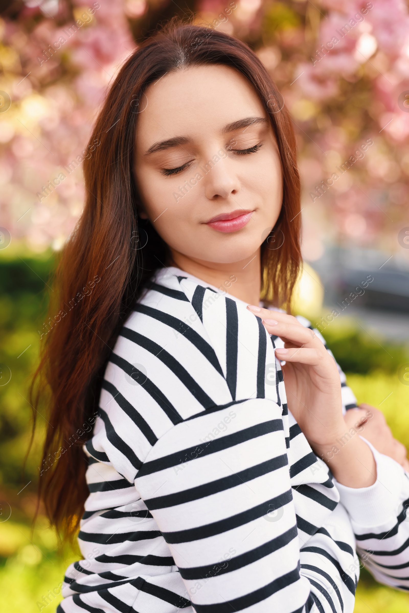 Photo of Beautiful woman near blossoming tree on spring day