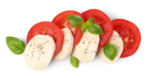 Photo of Delicious Caprese salad with tomatoes, mozzarella cheese, basil leaves and herbs isolated on white, top view