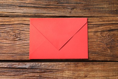 Photo of Letter envelope on wooden table, top view