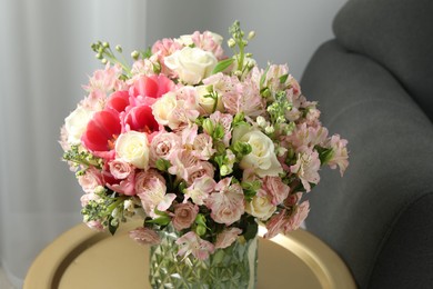 Beautiful bouquet of fresh flowers on coffee table in room