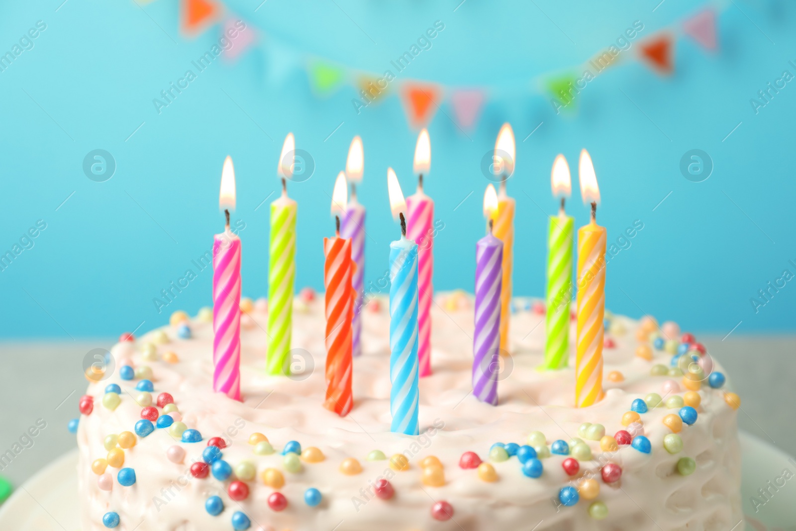 Photo of Delicious birthday cake with burning candles, closeup