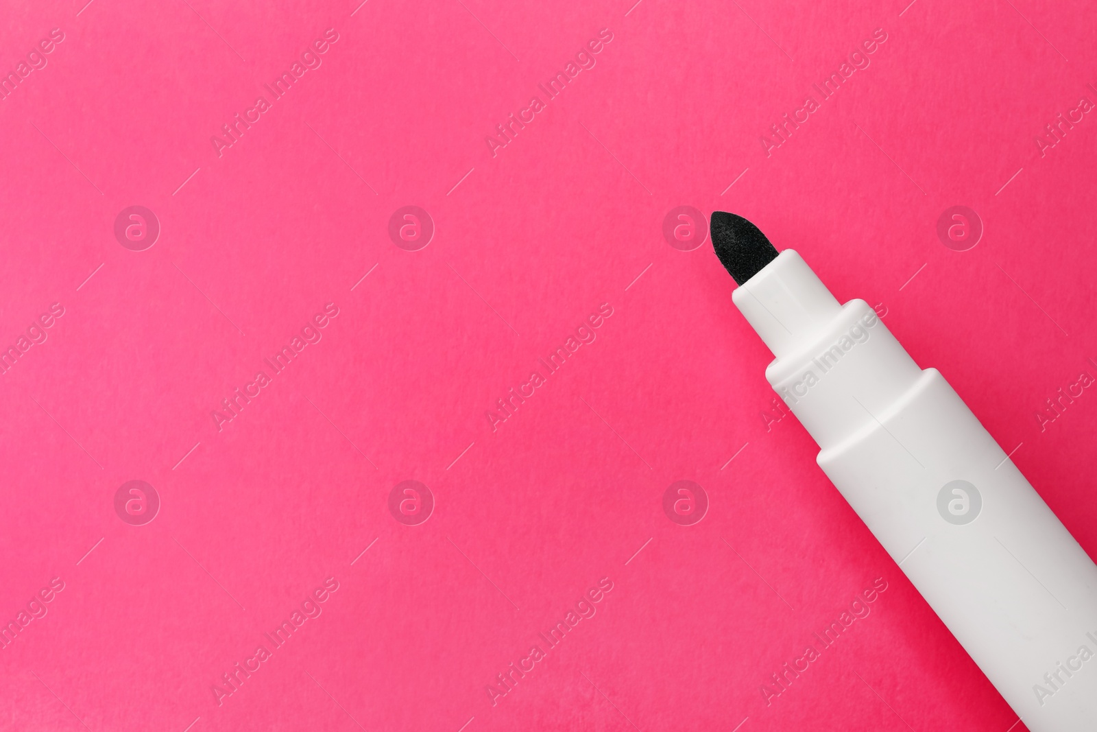 Photo of Bright green marker on pink background, top view. Space for text