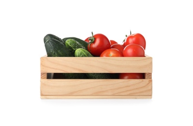 Wooden crate full of fresh vegetables on white background