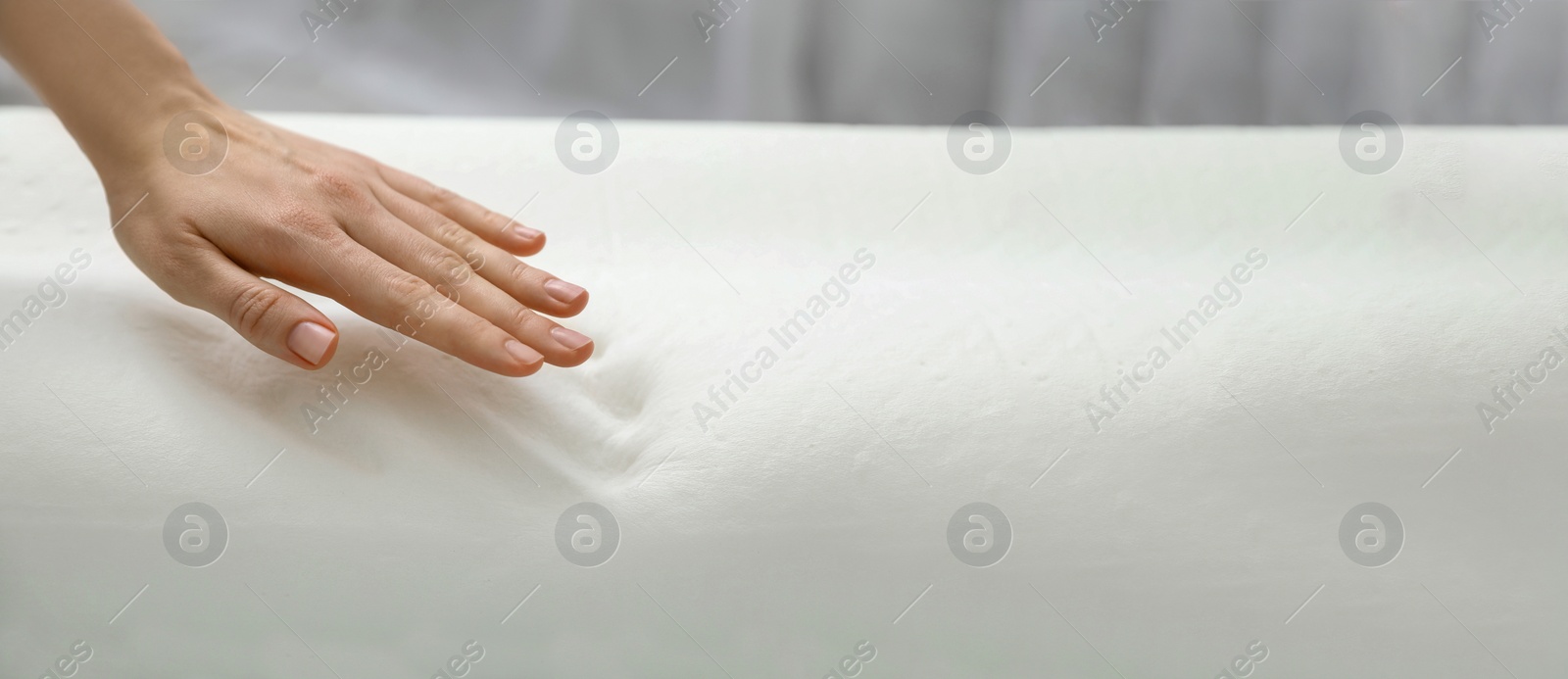 Image of Woman touching memory foam pillow indoors, closeup. Banner design with space for text
