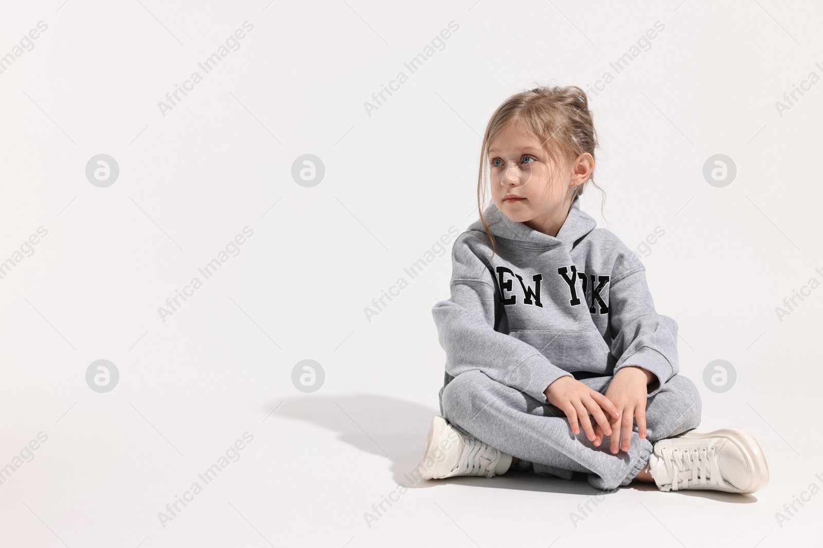 Photo of Fashion concept. Stylish girl posing on white background