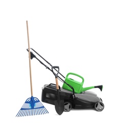 Photo of Modern electric grass cutter and gardening tools on white background