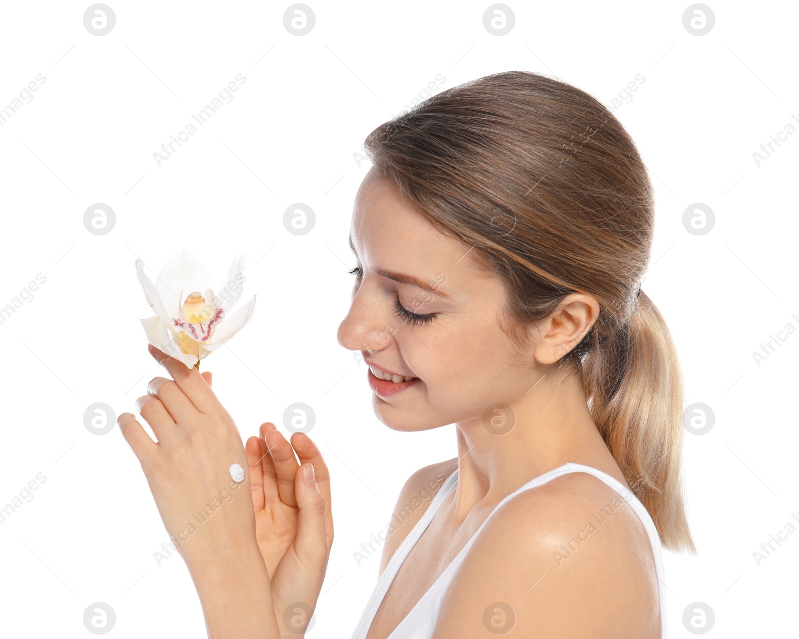 Photo of Young woman with flower applying hand cream on white background. Beauty and body care