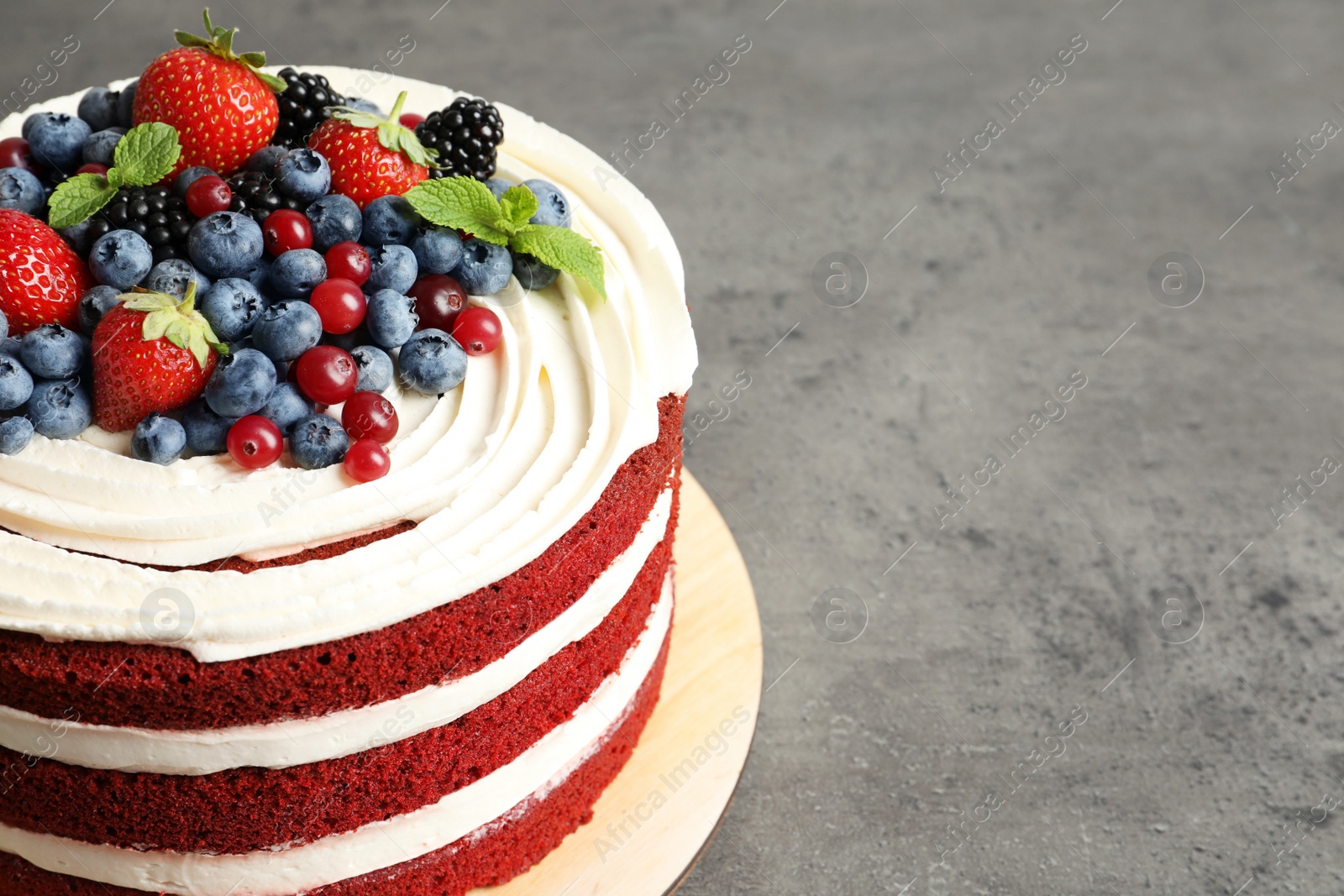 Photo of Delicious homemade red velvet cake and space for text on table