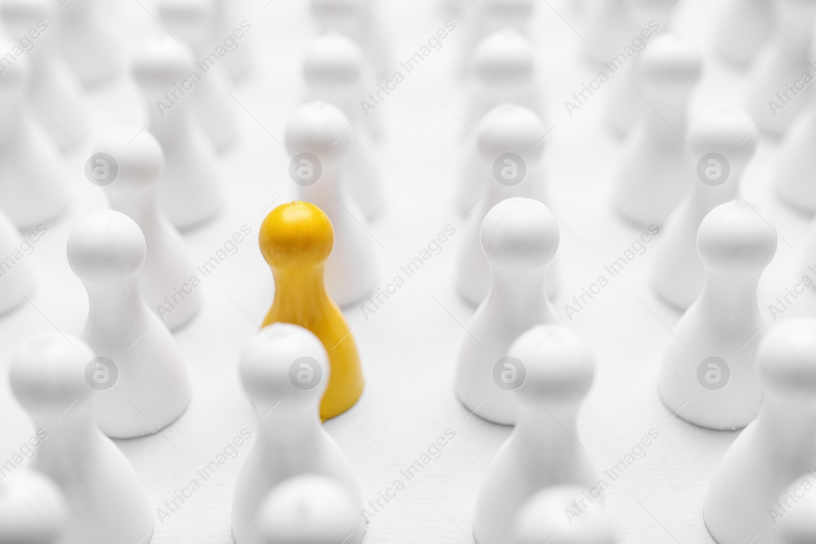 Photo of Yellow pawn among others on white background, closeup. Recruiter searching employee