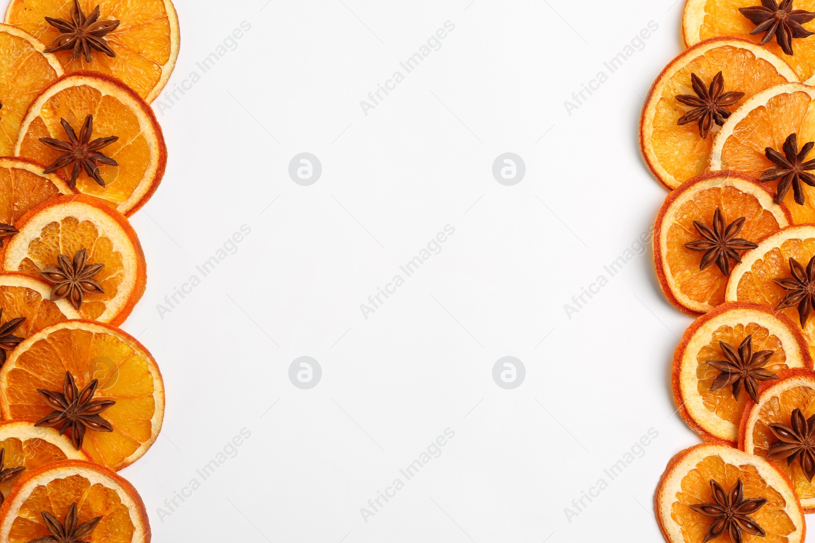 Photo of Flat lay composition with dry orange slices and anise stars on white background. Space for text