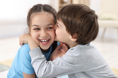 Happy brother and sister spending time together at home