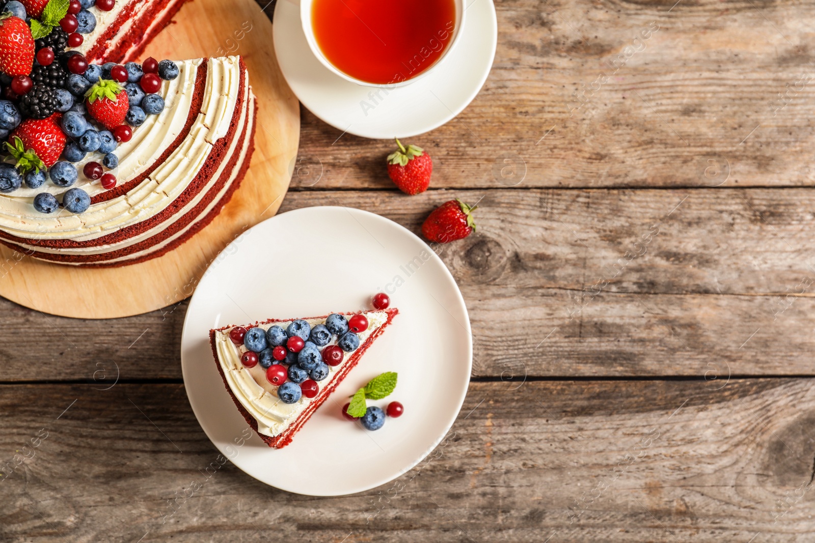 Photo of Flat lay composition with delicious red velvet cake and space for text on wooden table