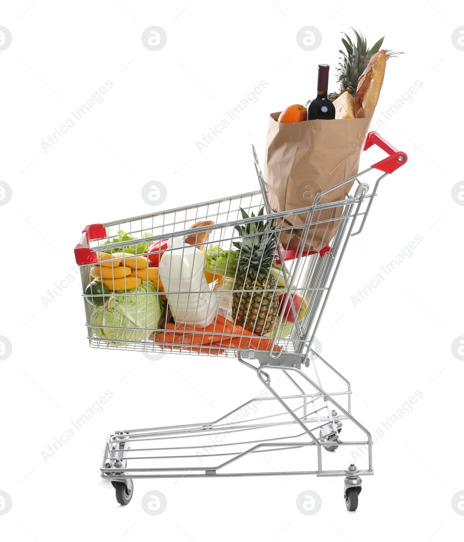 Photo of Shopping cart with groceries on white background