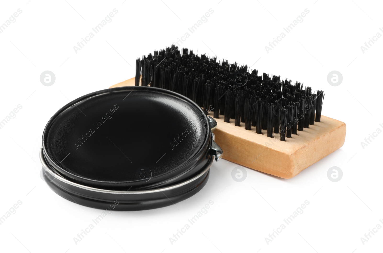 Photo of Black polish with brush on white background. Shoe care accessories