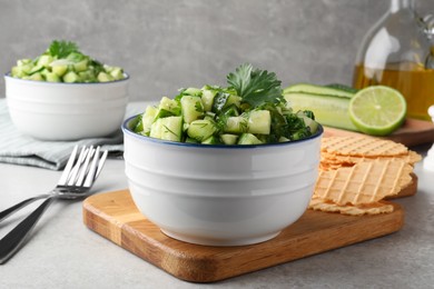Photo of Bowldelicious cucumber salad served on light table