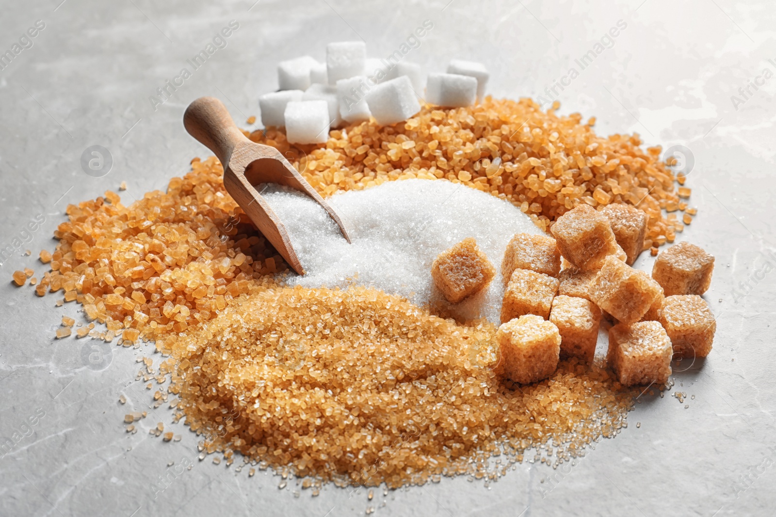 Photo of Composition with different types of sugar on table