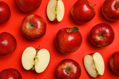 Photo of Flat lay composition with ripe juicy apples on red background