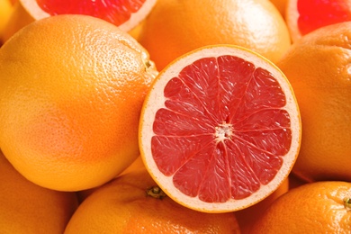 Photo of Many fresh ripe grapefruits as background, closeup