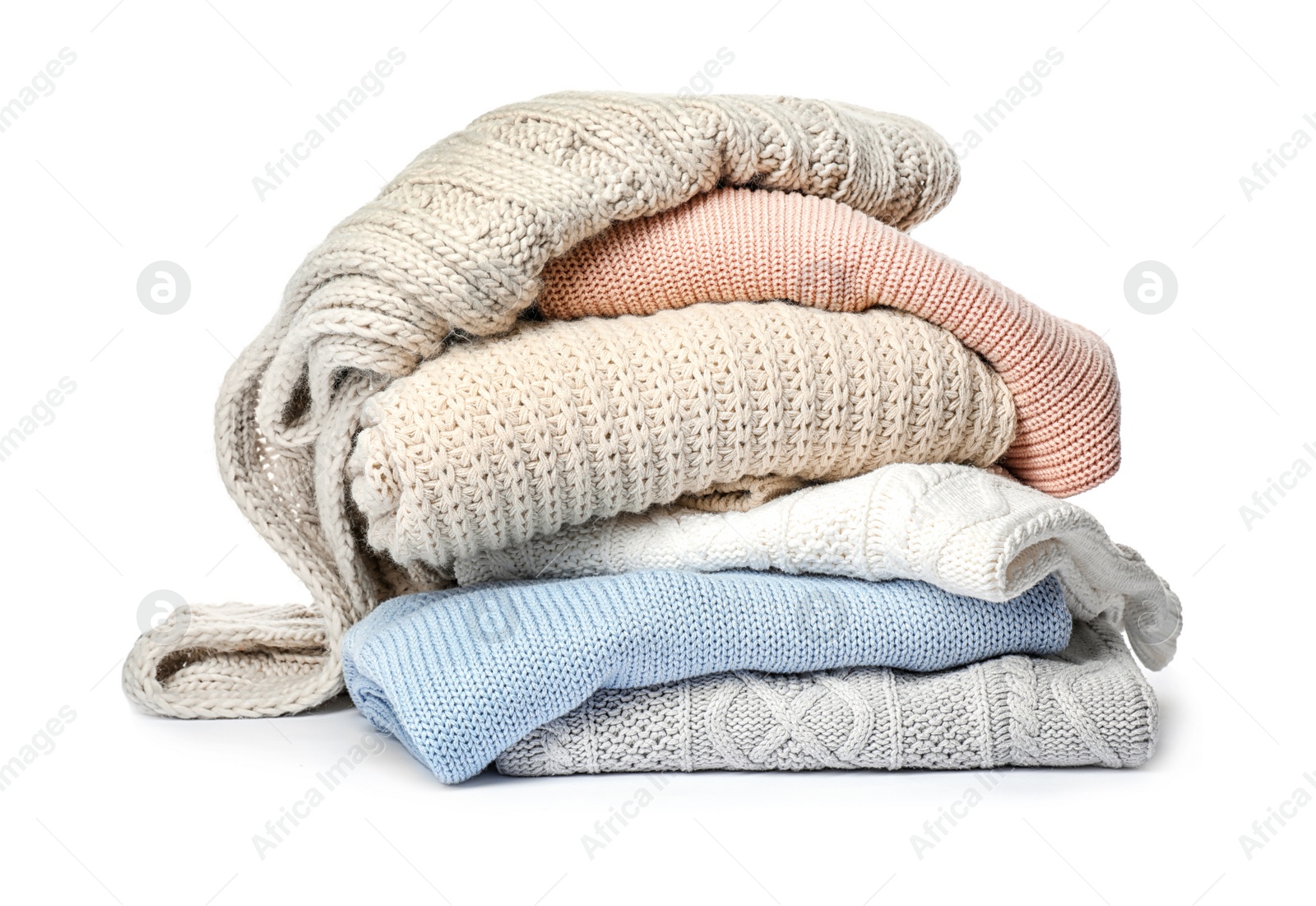 Photo of Stack of folded knitted sweaters on white background