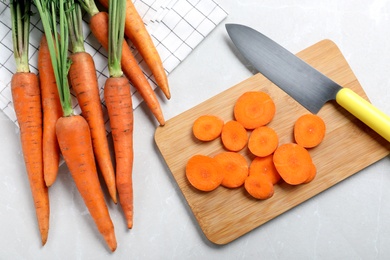 Photo of Flat lay composition with ripe carrots on light grey marble table
