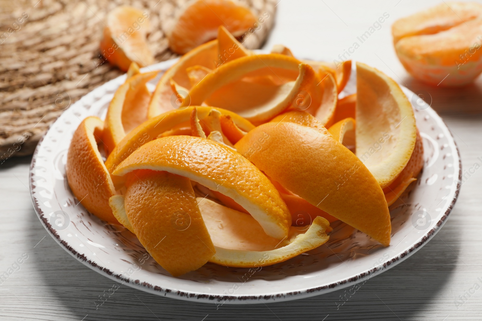 Photo of Orange peels preparing for drying on white wooden table, closeup