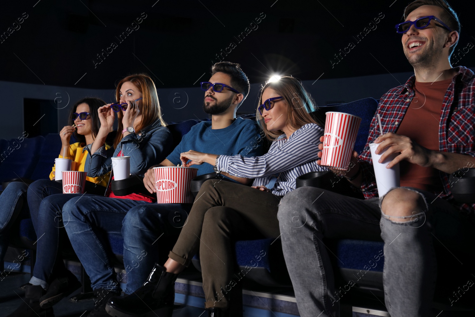 Photo of Young people watching movie in cinema theatre