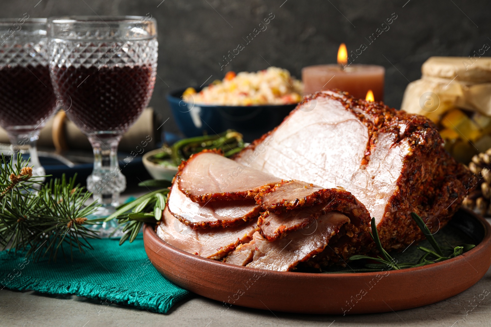 Photo of Delicious Christmas ham served with garnish on table