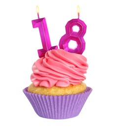 Delicious cupcake with number shaped candles on white background. Coming of age party - 18th birthday