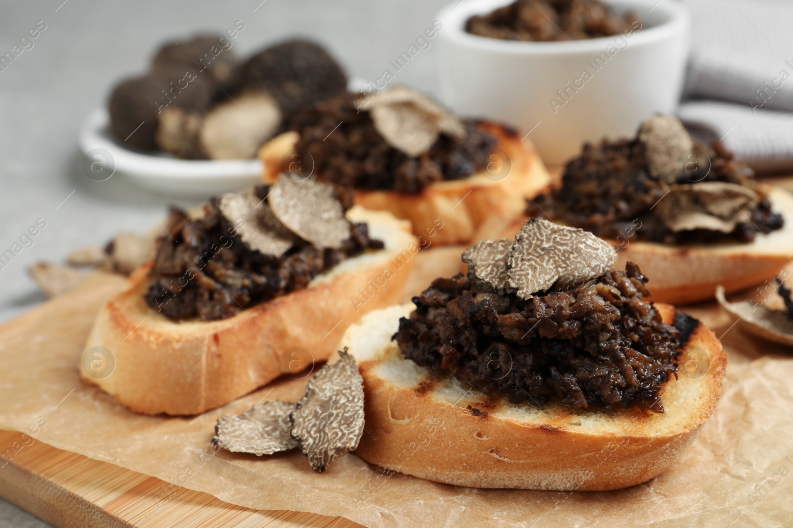 Photo of Delicious bruschettas with truffle sauce on table, closeup