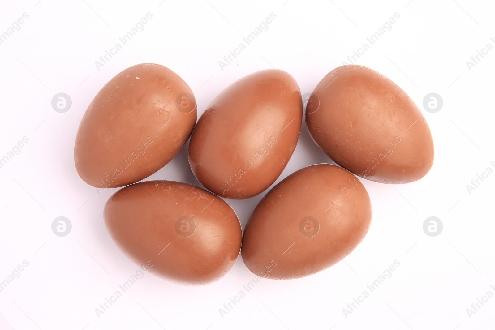 Photo of Sveti Vlas, Bulgaria - June 27, 2023: Unwrapped Kinder Surprise Eggs isolated on white, top view