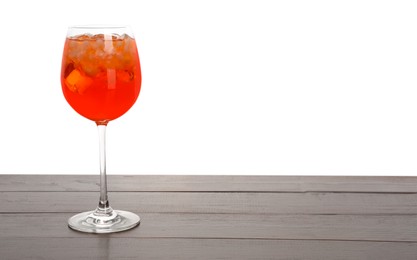 Photo of Aperol spritz cocktail and ice cubes in glass on wooden table against white background, space for text