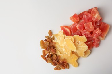 Photo of Pile of different dried fruits on white background, top view. Space for text