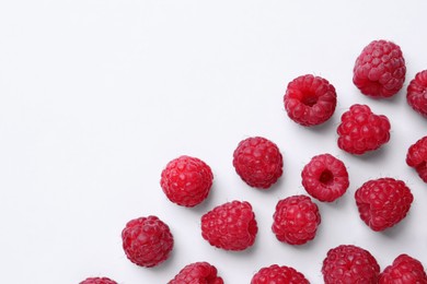 Photo of Tasty ripe raspberries on white background, flat lay. Space for text