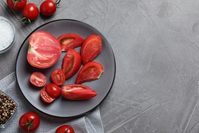 Photo of Delicious fresh tomatoes on grey table, flat lay. Space for text