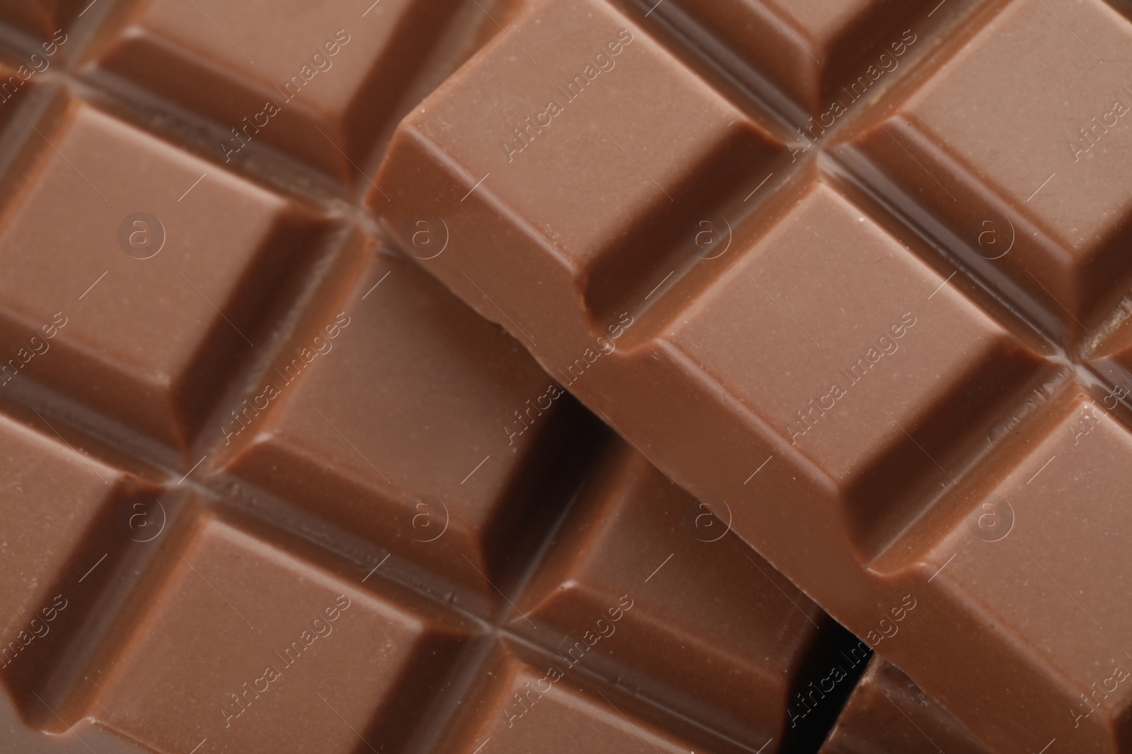 Photo of Delicious milk chocolate as background, closeup view