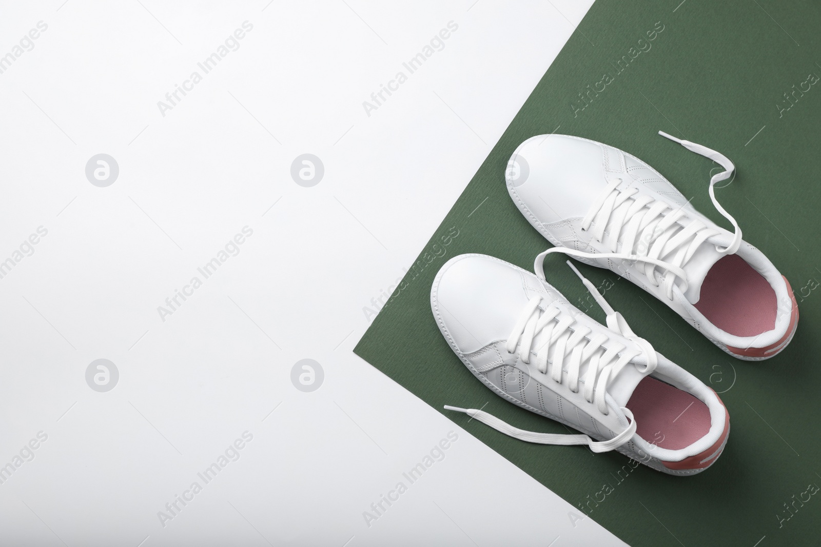 Photo of Pair of sneakers on color background, flat lay. Space for text