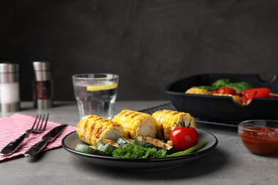 Photo of Delicious grilled vegetables served on grey table