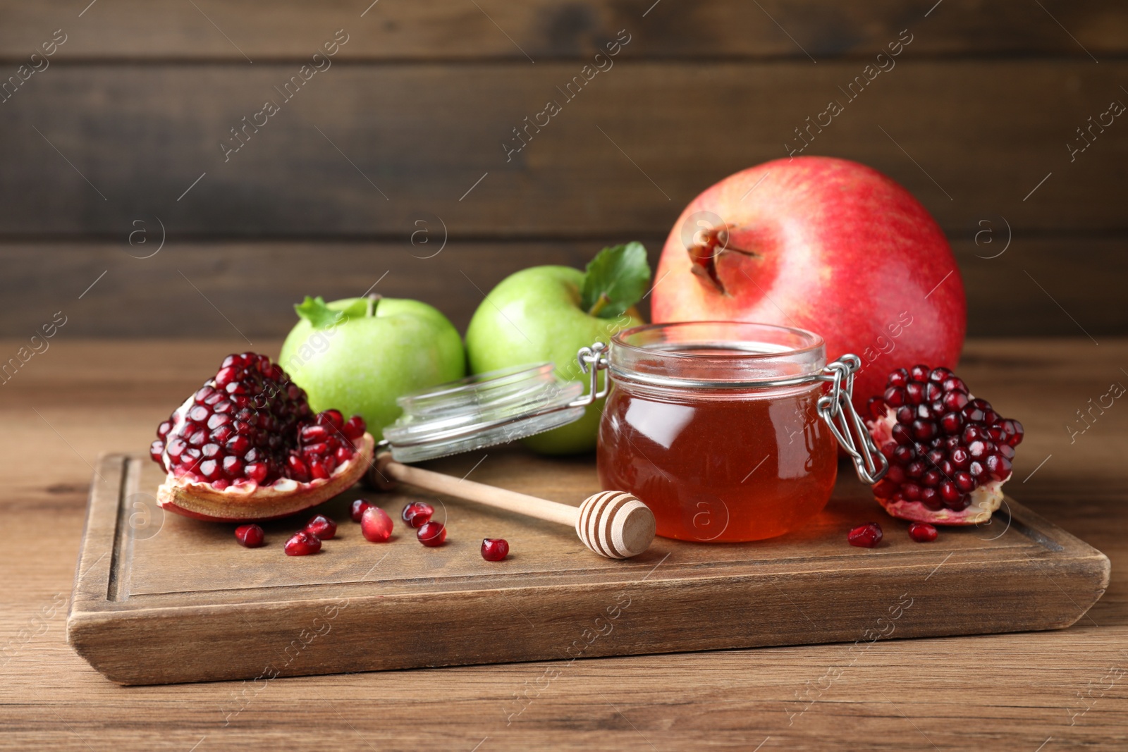 Photo of Honey, pomegranate and apples on wooden table. Rosh Hashana holiday