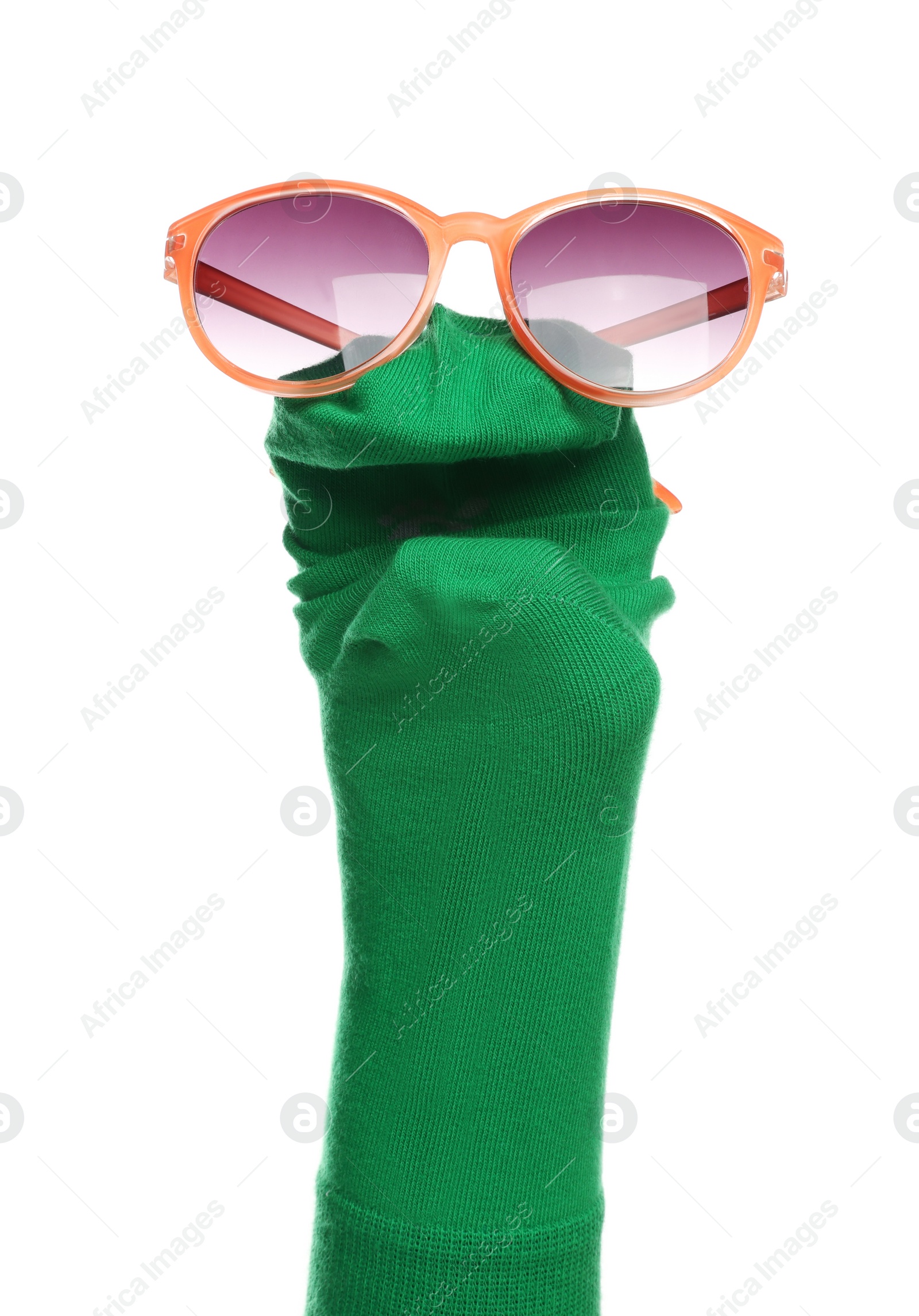 Photo of Funny sock puppet with sunglasses isolated on white