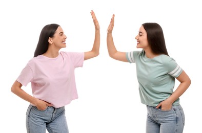 Photo of Women giving high five on white background