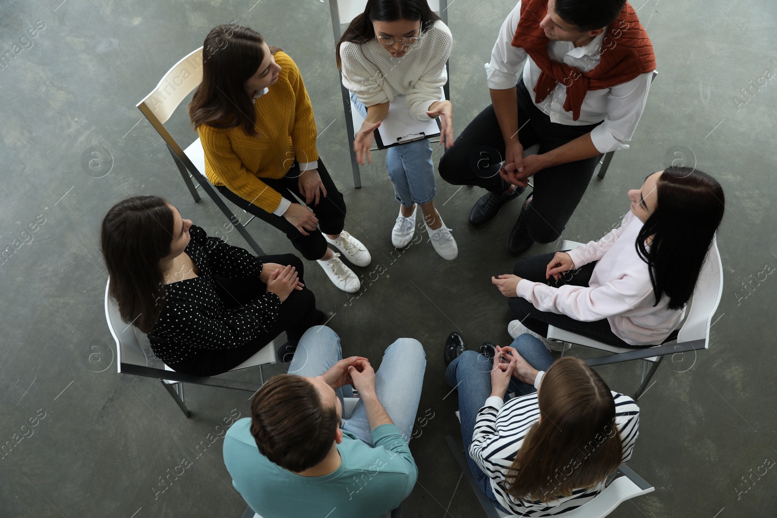 Photo of Psychotherapist working with patients in group therapy session, top view