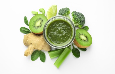 Photo of Delicious green juice and fresh ingredients on white background, top view
