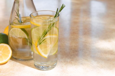 Tasty refreshing lemonade and ingredients on light table, space for text. Summer drink