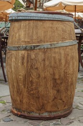 Photo of Traditional wooden barrel on city street outdoors