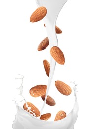 Delicious almond milk and nuts on white background