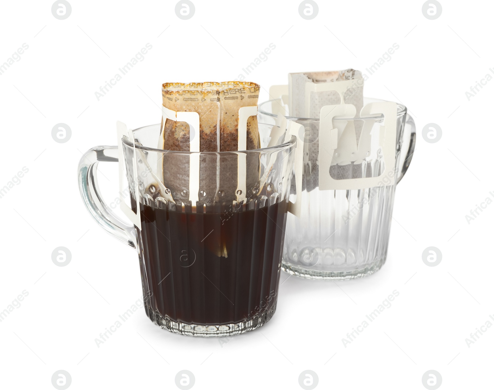 Photo of Glass cups with drip coffee bags isolated on white