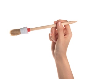 Photo of Woman holding paint brush on white background, closeup