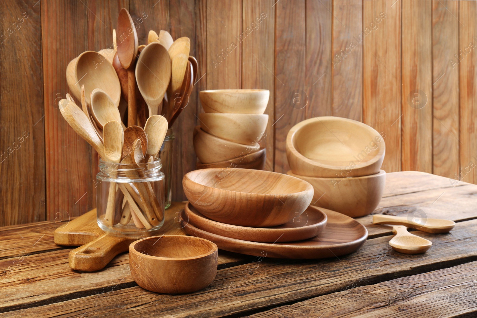 Photo of Many different wooden dishware and utensils on table