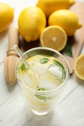 Photo of Cool freshly made lemonade and fruits on white wooden table, above view