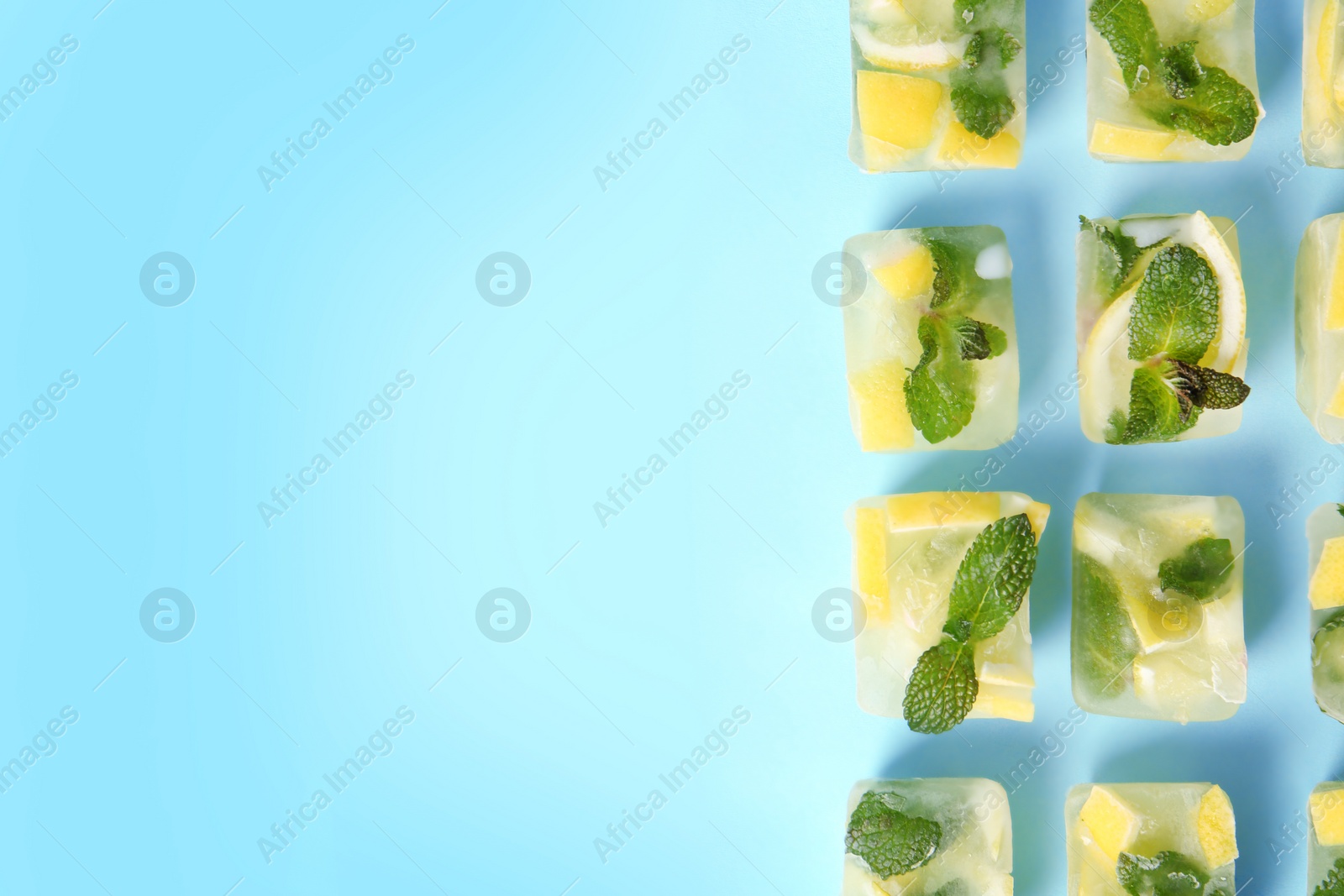 Photo of Flat lay composition with lemon and mint ice cubes on color background. Space for text